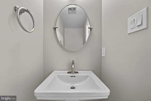 a bathroom with a sink and mirror