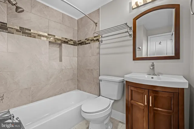 a bathroom with a sink toilet vanity and shower