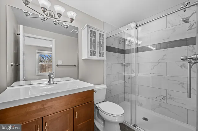 a view of an empty room with a fireplace and a window