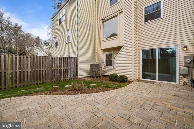 a view of a house with a small yard and wooden fence