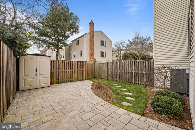 a view of a brick building next to a yard