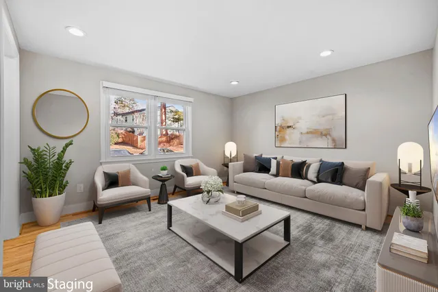 a living room with furniture a widow and a lamp