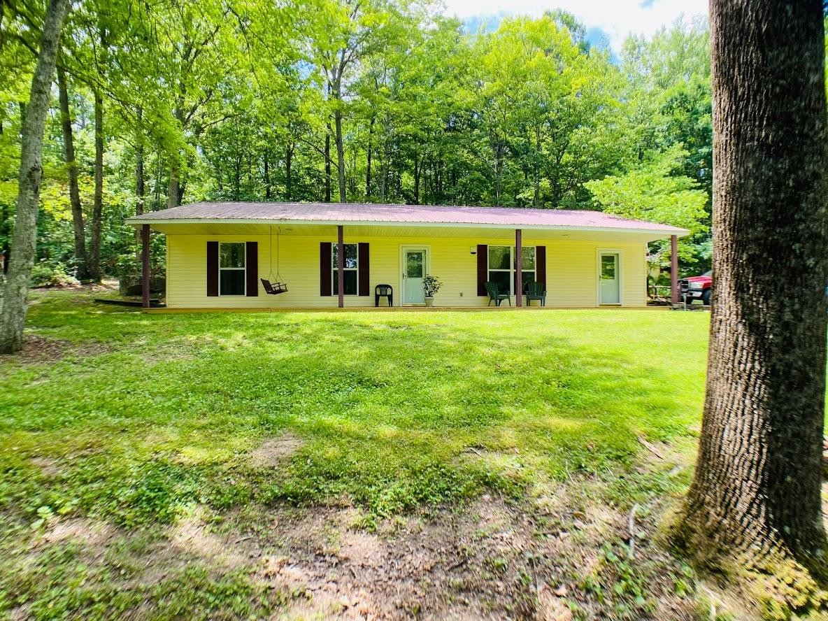 1034 Star Point Road Jamestown, TN 38556 - Photo 1 of 35 a front view of a house with garden