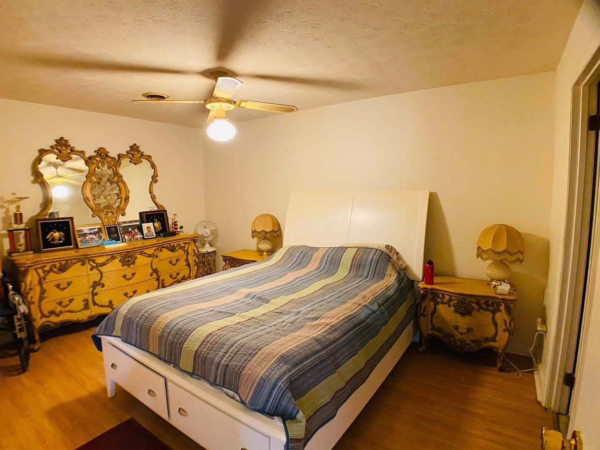 1034 Star Point Road Jamestown, TN 38556 - Photo 18 of 35 a bed room with a bed and a chandelier