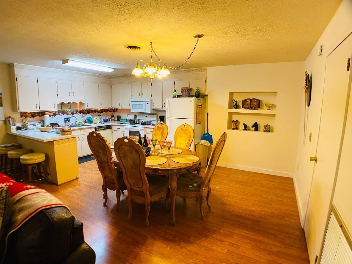 1034 Star Point Road Jamestown, TN 38556 - Photo 25 of 35 a view of a dining room with furniture and a chandelier