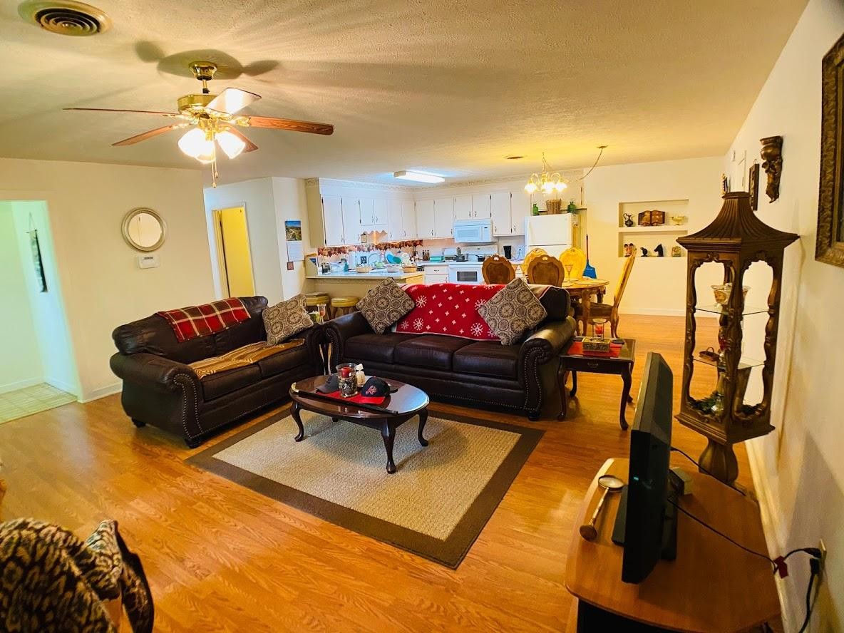 1034 Star Point Road Jamestown, TN 38556 - Photo 26 of 35 a living room with furniture kitchen view and a chandelier