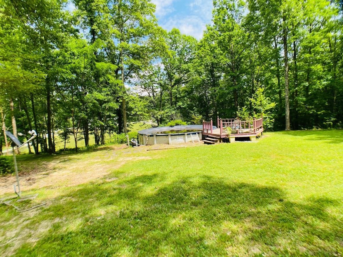 1034 Star Point Road Jamestown, TN 38556 - Photo 9 of 35 a view of a swimming pool with a bench and trees around