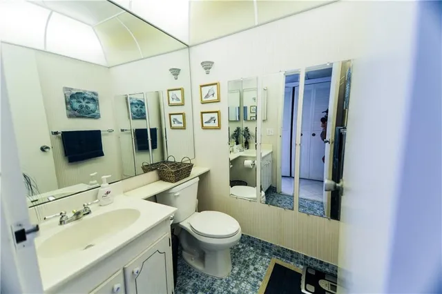 a bathroom with a toilet sink a mirror and shower