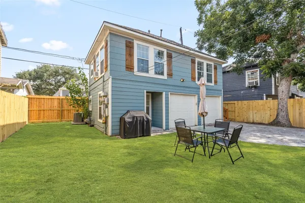 a view of a house with a backyard and a patio