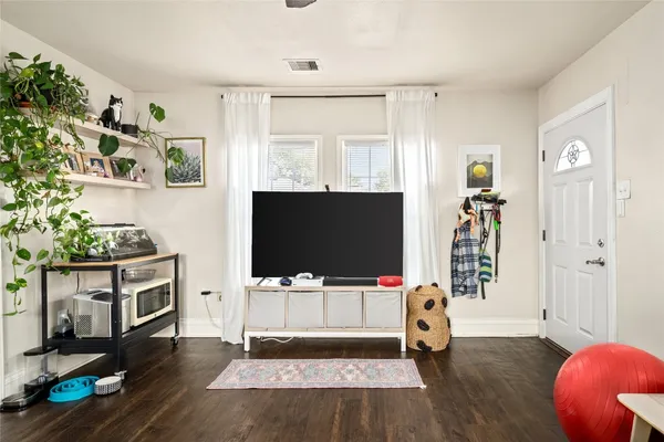 a living room with furniture and a flat screen tv