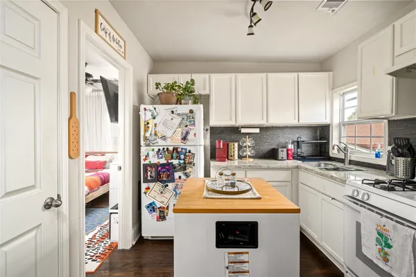 a view of a kitchen with a stove top oven