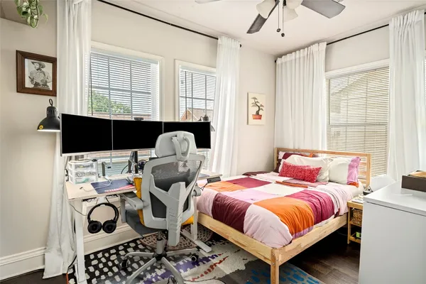 a bedroom with a bed and wooden floor