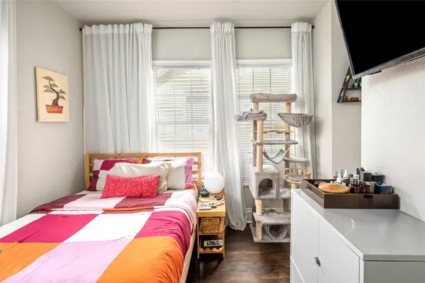 a bedroom with a bed and a window
