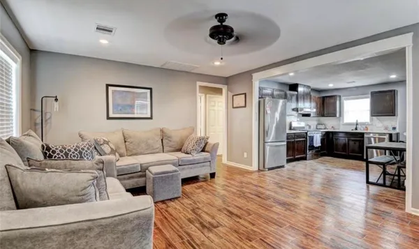 a living room with furniture and kitchen view