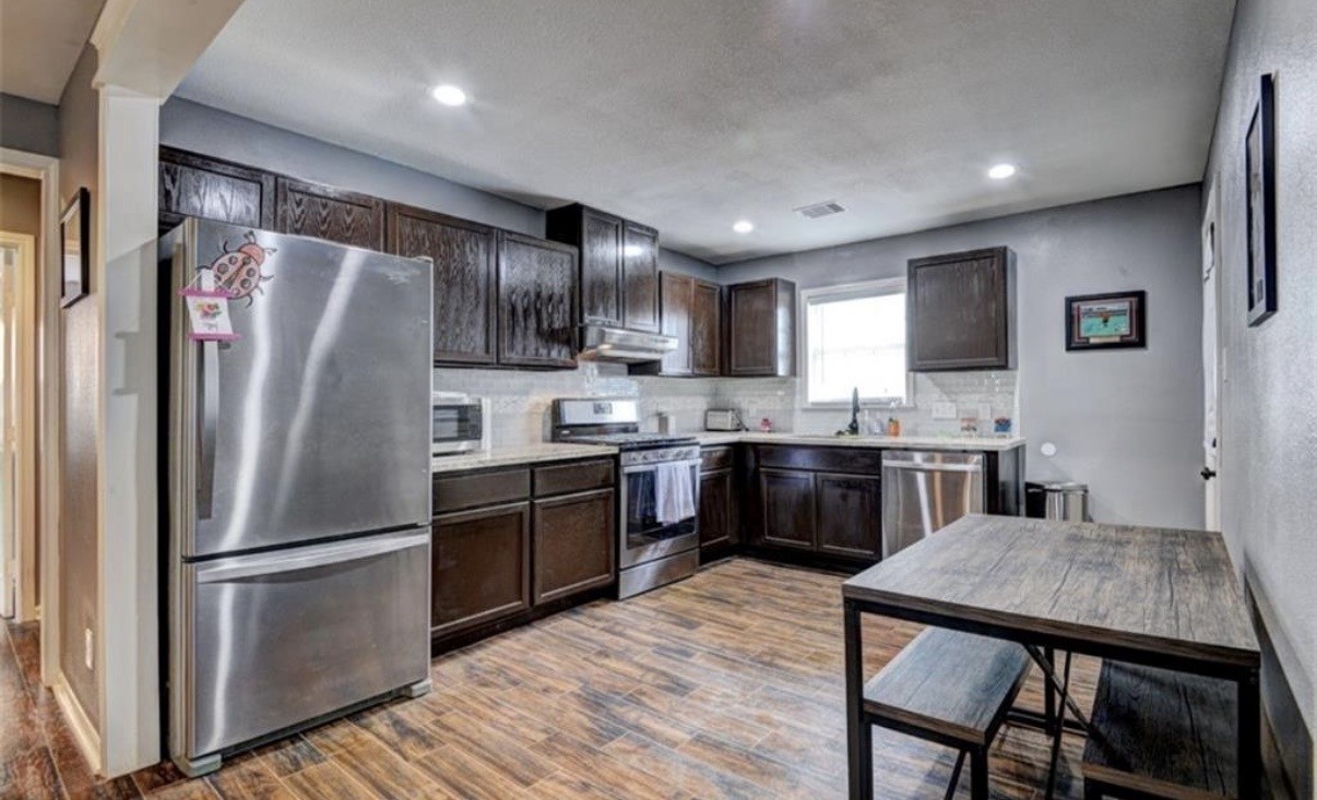 5227 Lawndale Street Houston, TX 77023 - Photo 7 of 32 a kitchen with stainless steel appliances granite countertop a refrigerator a stove a sink a microwave and a refrigerator