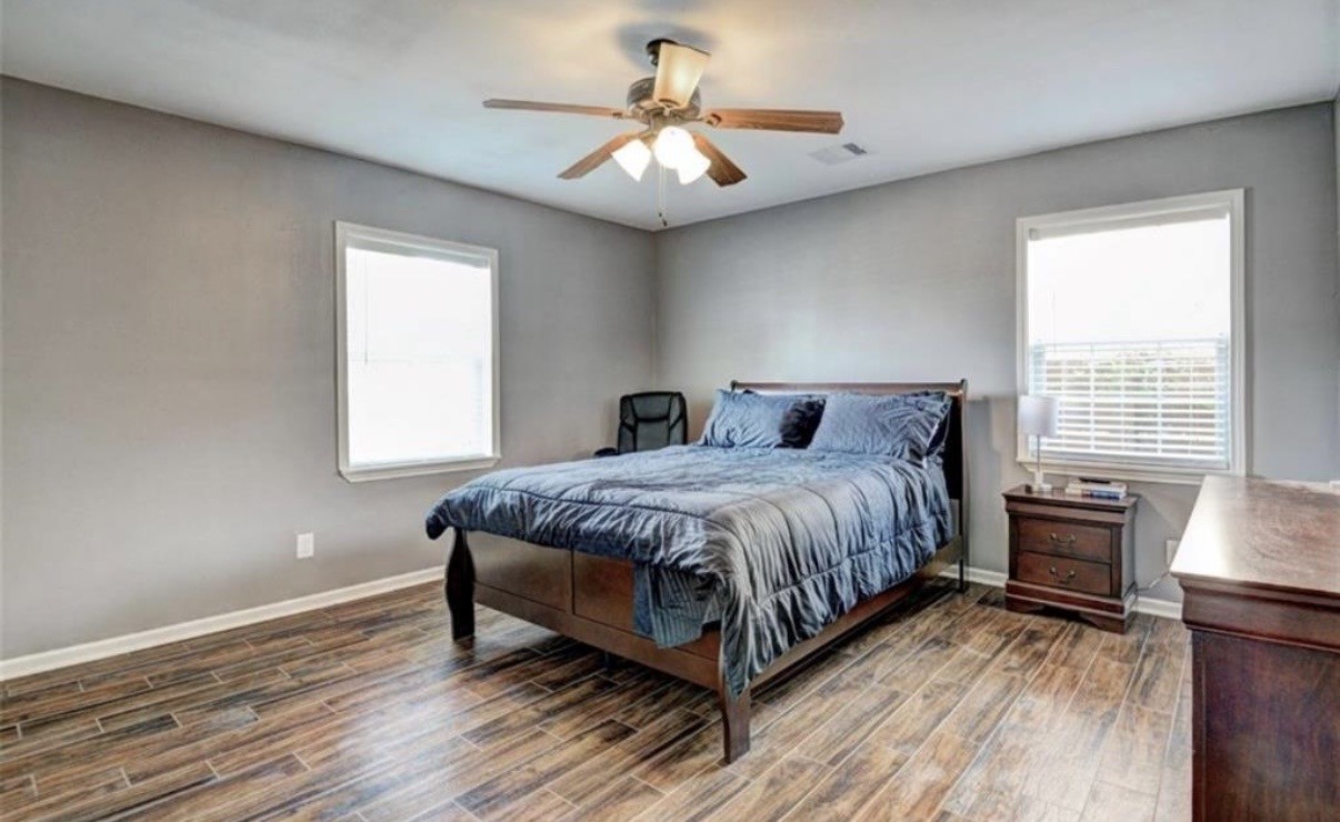 5227 Lawndale Street Houston, TX 77023 - Photo 9 of 32 a spacious bedroom with a bed and a chandelier