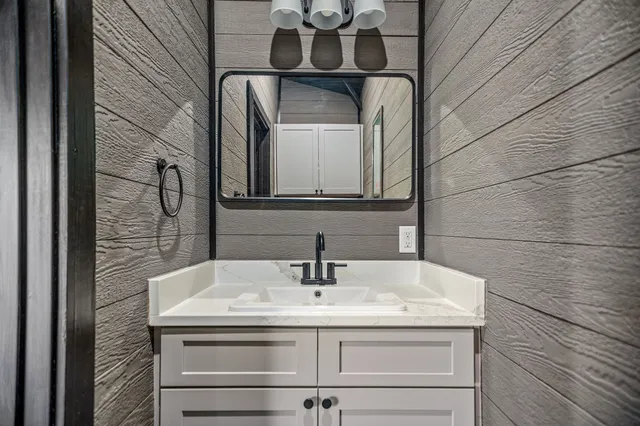 a view of a big yard with a fountain and large trees