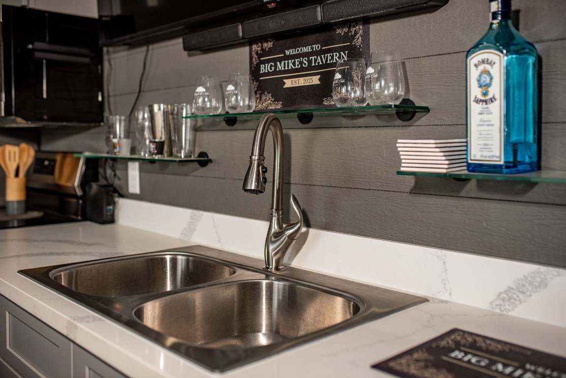 1236 Riverside Drive Palacios, TX 77465 - Photo 13 of 35 a kitchen with a sink and chandelier