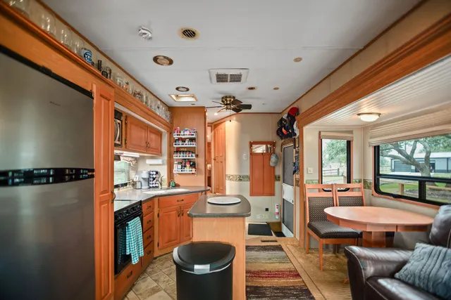 a view of a house with a tree in the yard