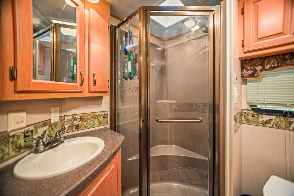 1236 Riverside Drive Palacios, TX 77465 - Photo 21 of 35 a bathroom with a sink a mirror and a shower