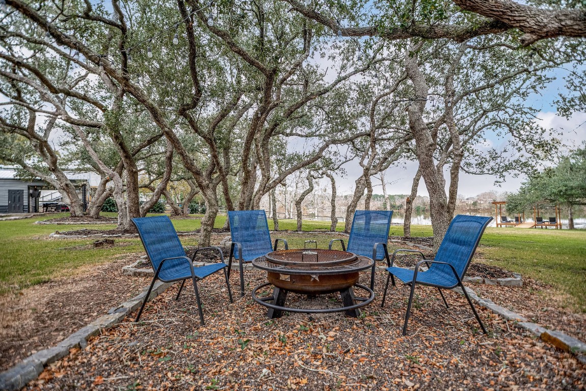1236 Riverside Drive Palacios, TX 77465 - Photo 23 of 35 a backyard of a house with table and chairs