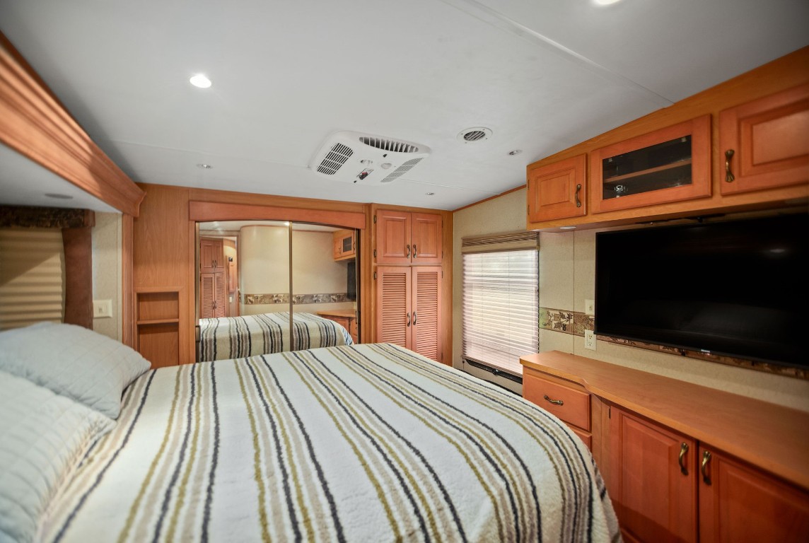1236 Riverside Drive Palacios, TX 77465 - Photo 24 of 35 a bedroom with a bed and a flat screen tv