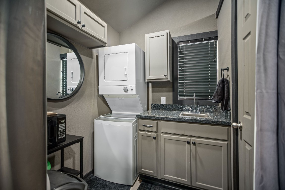 1236 Riverside Drive Palacios, TX 77465 - Photo 28 of 35 a bathroom with a granite countertop toilet sink and mirror