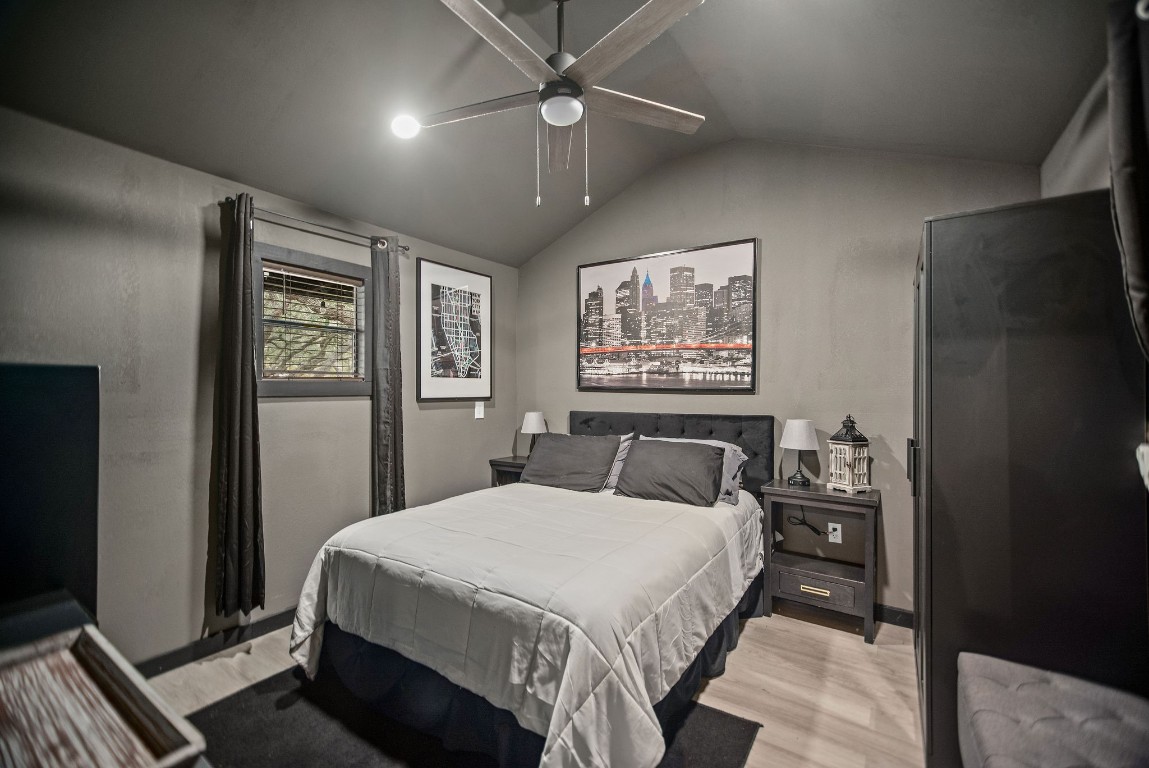 1236 Riverside Drive Palacios, TX 77465 - Photo 31 of 35 a bedroom with a large bed a chandelier and closet