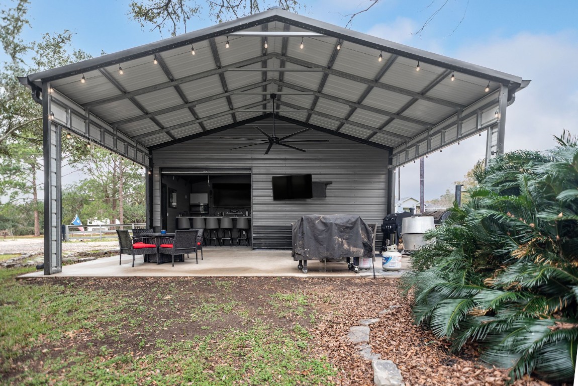 1236 Riverside Drive Palacios, TX 77465 - Photo 7 of 35 a backyard of a house with yard and outdoor seating
