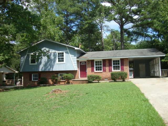 6642 Bedford Road Rex, GA 30273 - Photo 1 of 1 a front view of a house with a yard and trees