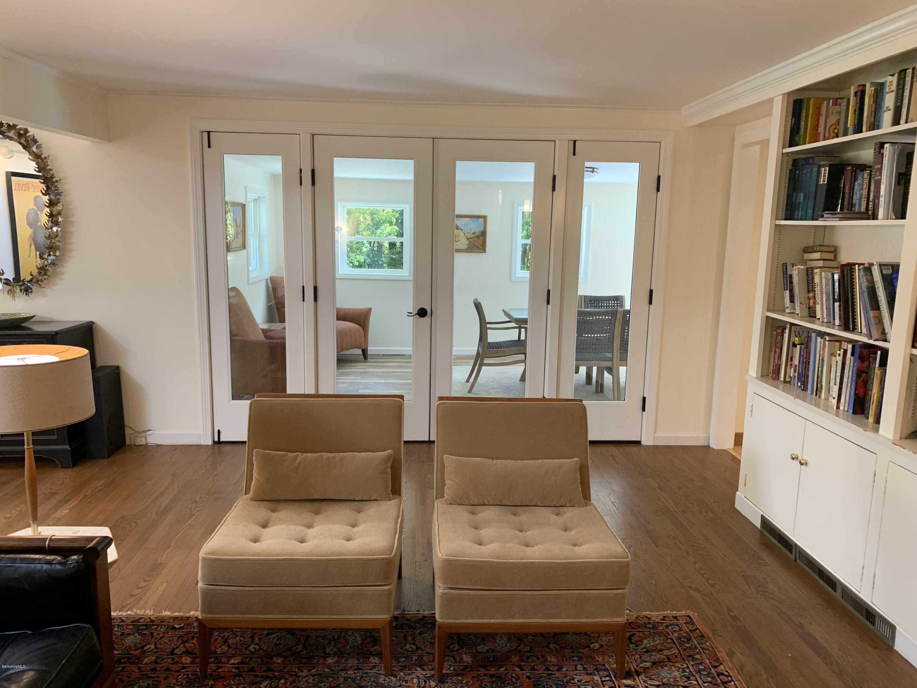 261 Old Stockbridge Road Lenox, MA 01240 - Photo 11 of 43 a living room with furniture and a book shelf