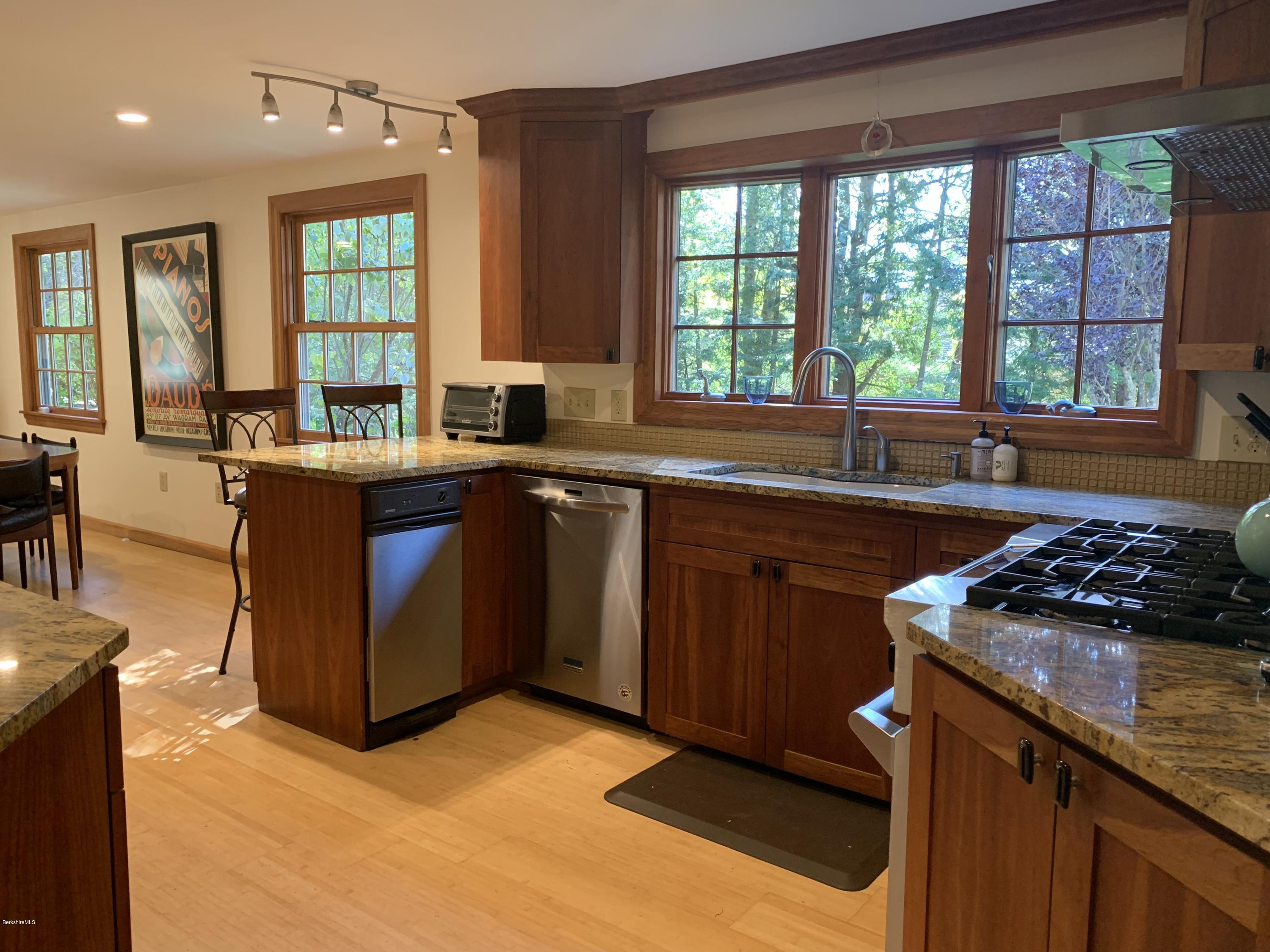 261 Old Stockbridge Road Lenox, MA 01240 - Photo 14 of 43 a kitchen with a stove a sink and a microwave
