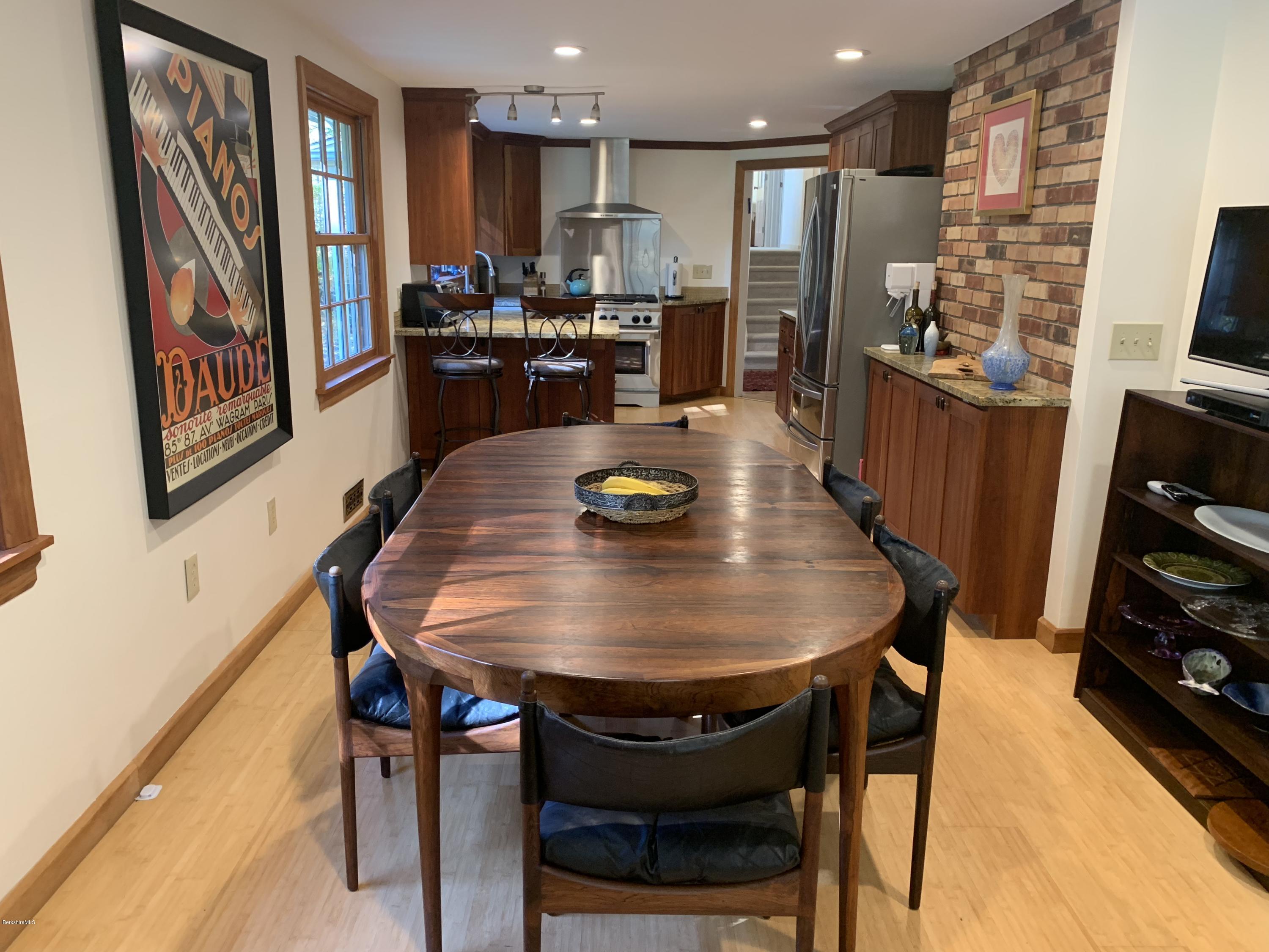 261 Old Stockbridge Road Lenox, MA 01240 - Photo 19 of 43 a dining room with furniture and wooden floor