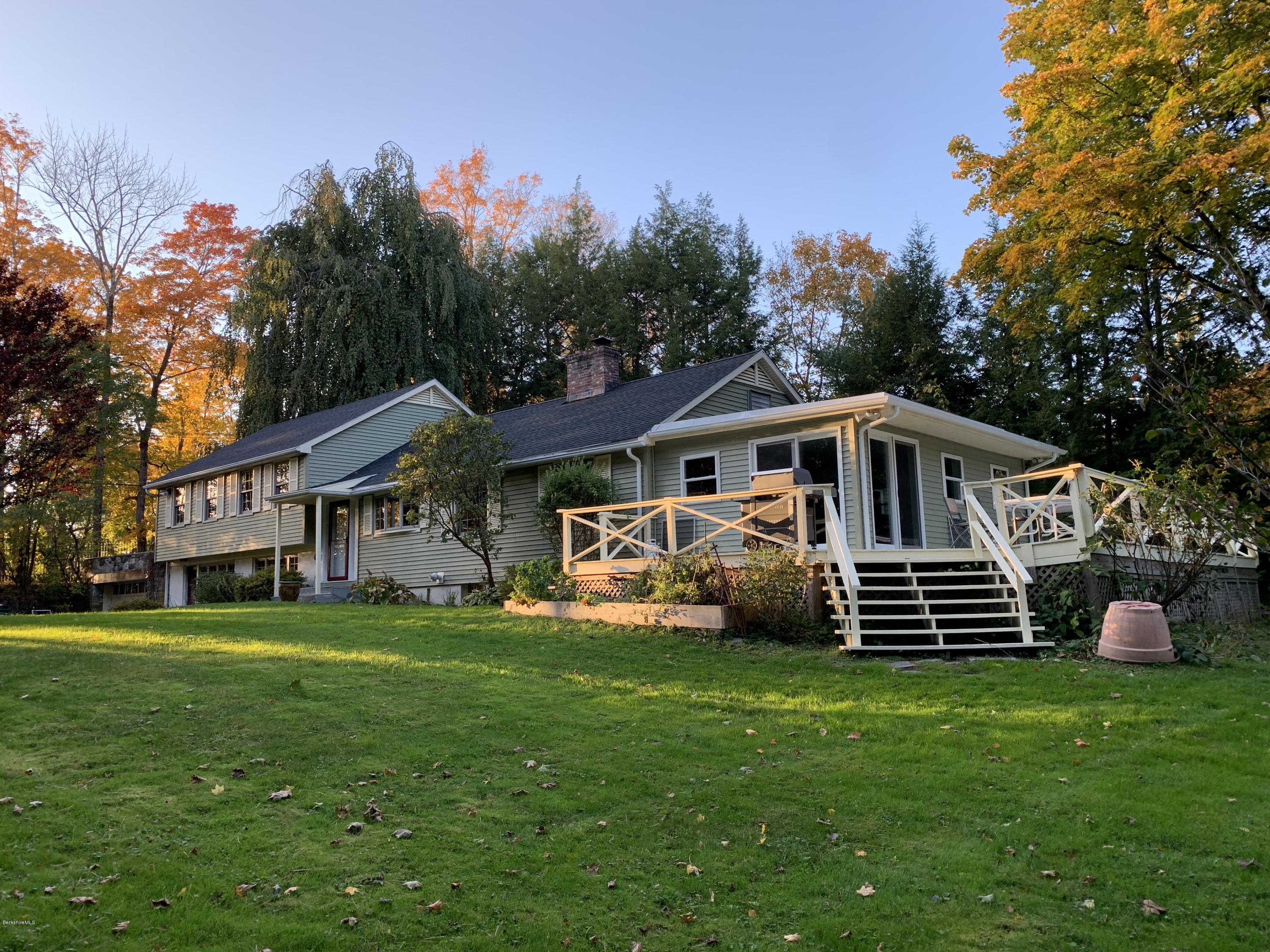 261 Old Stockbridge Road Lenox, MA 01240 - Photo 3 of 43 a front view of a house with a garden