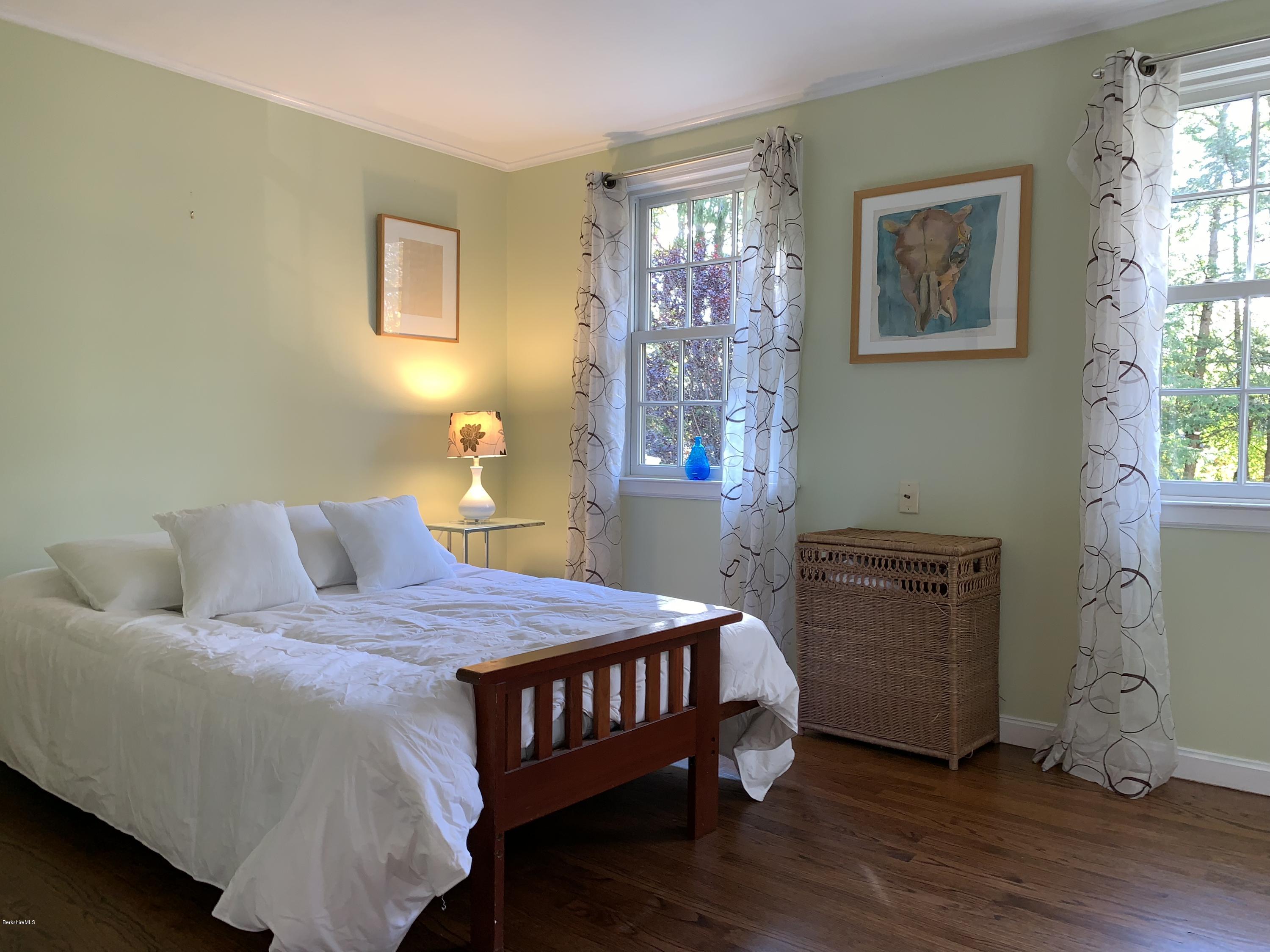 261 Old Stockbridge Road Lenox, MA 01240 - Photo 23 of 43 a bedroom with a bed and wooden floor