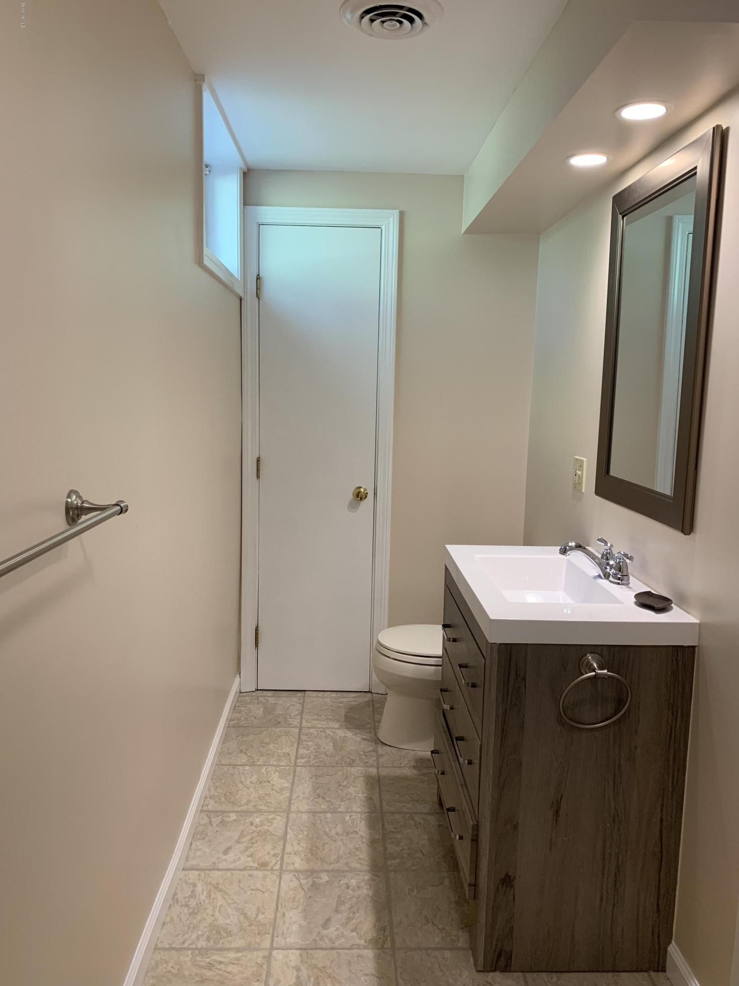 261 Old Stockbridge Road Lenox, MA 01240 - Photo 29 of 43 a bathroom with a sink a toilet and mirror