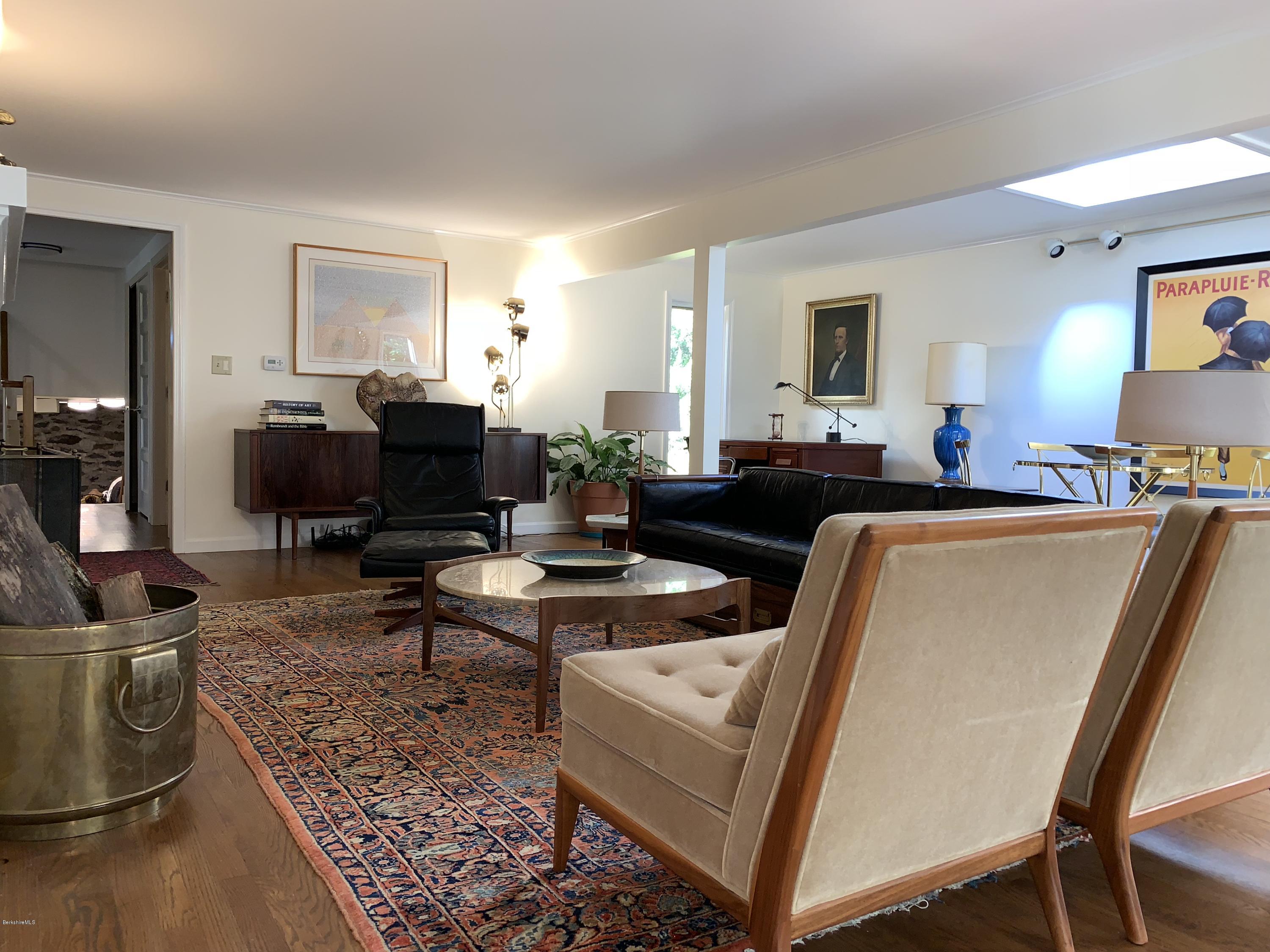 261 Old Stockbridge Road Lenox, MA 01240 - Photo 6 of 43 a living room with furniture a rug and a flat screen tv