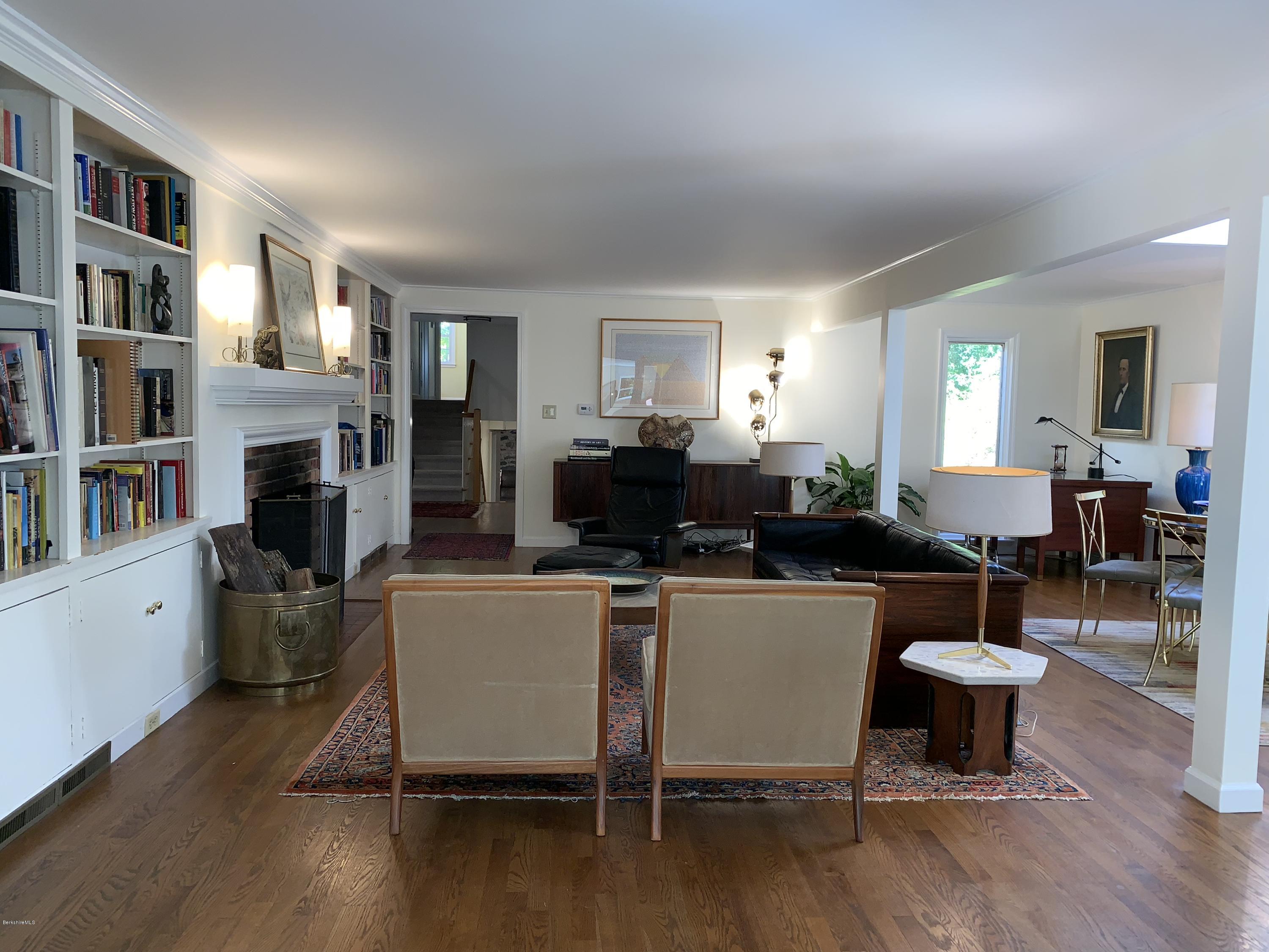 261 Old Stockbridge Road Lenox, MA 01240 - Photo 9 of 43 a living room with furniture a flat screen tv and a table