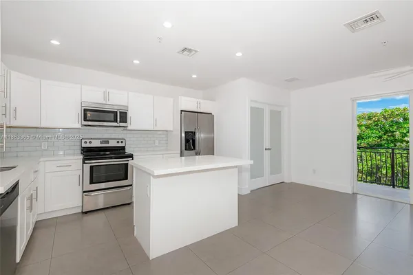 a kitchen with a stove and a microwave