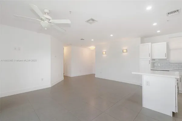 a view of a kitchen with a sink and a refrigerator