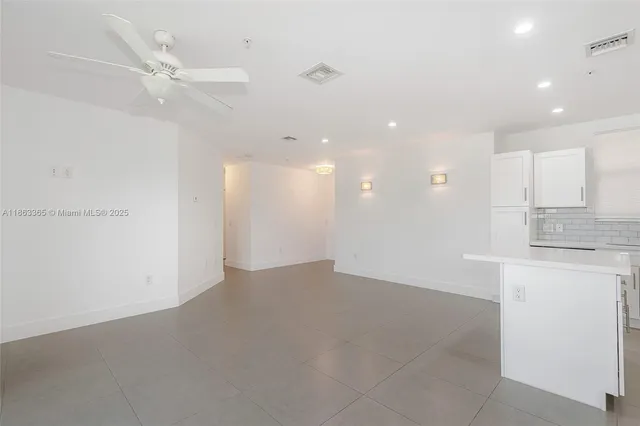 a kitchen with kitchen island a sink stainless steel appliances and cabinets