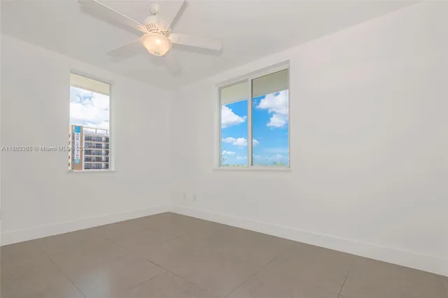 an empty room with windows and closet