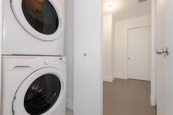 a view of a hallway with washer and dryer