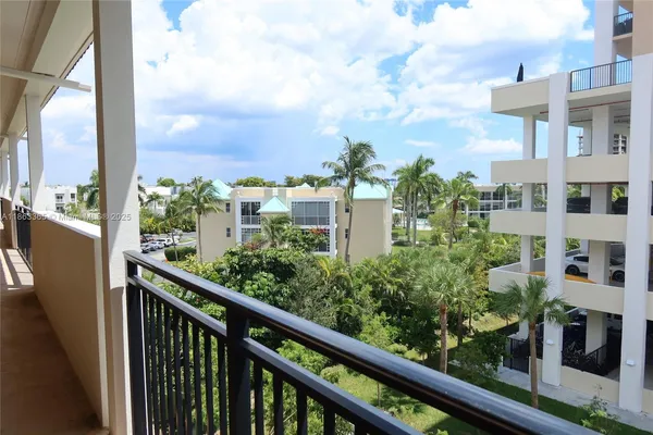 a view of a balcony with flower plants