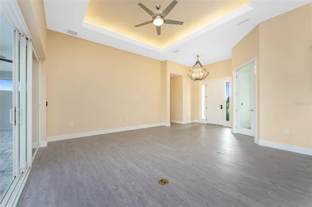 a large kitchen with a large counter top a sink stainless steel appliances and cabinets