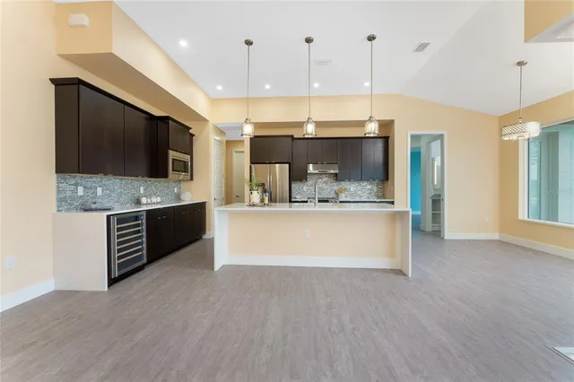 a kitchen with stainless steel appliances wooden cabinets and a sink