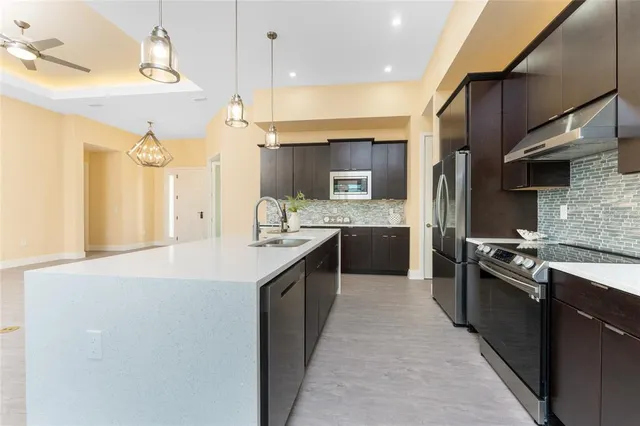 a view of a kitchen with a sink and wooden floor