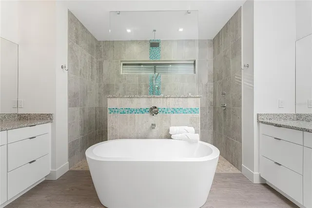 a bathroom with a granite countertop sink and white cabinets