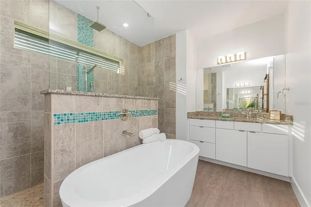 an empty room with a ceiling fan and wooden floor