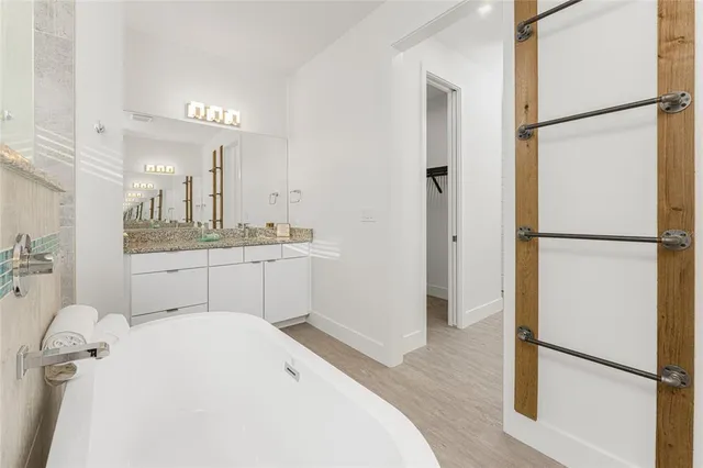 an empty room with wooden floor and closet